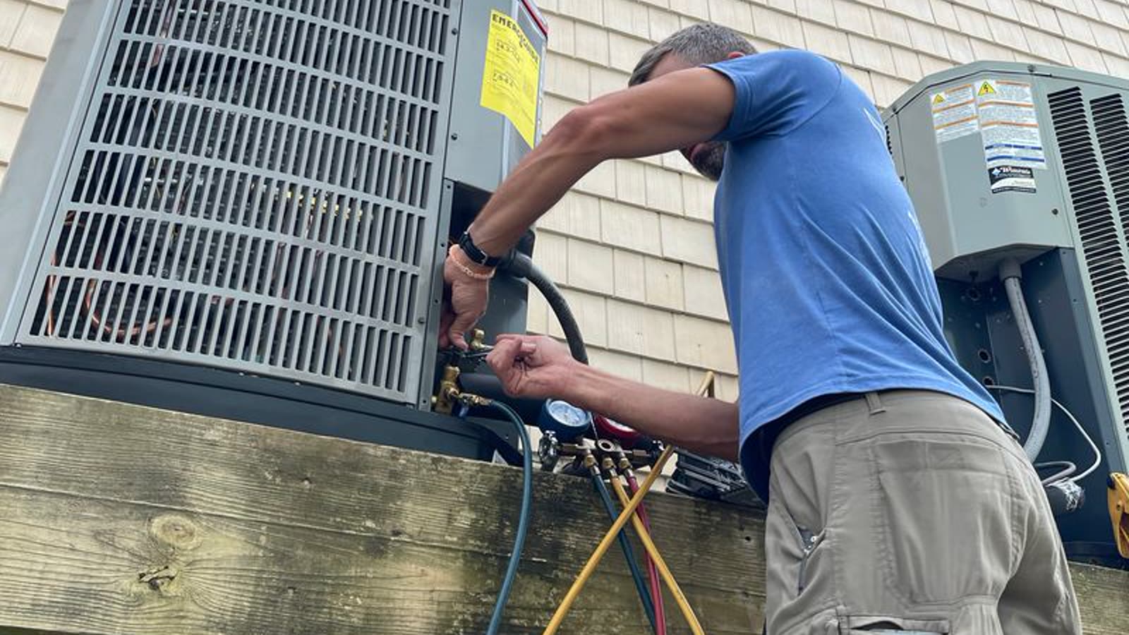 Sun City AC technician servicing outdoor cooling equipment